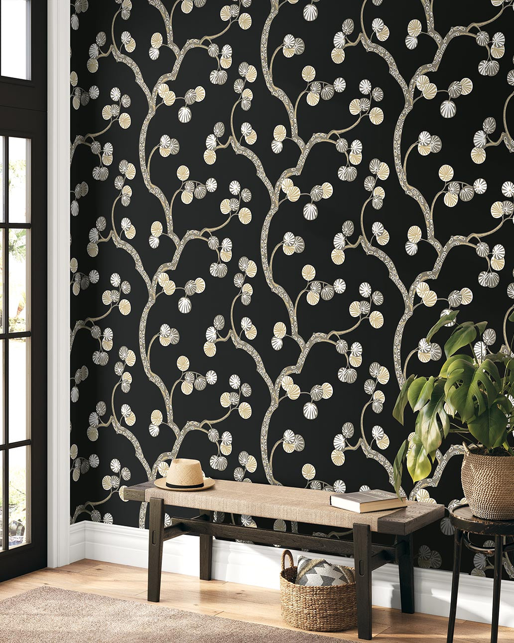 Wallpaper with floral pattern on a black background in a room with a wooden bench and plant.