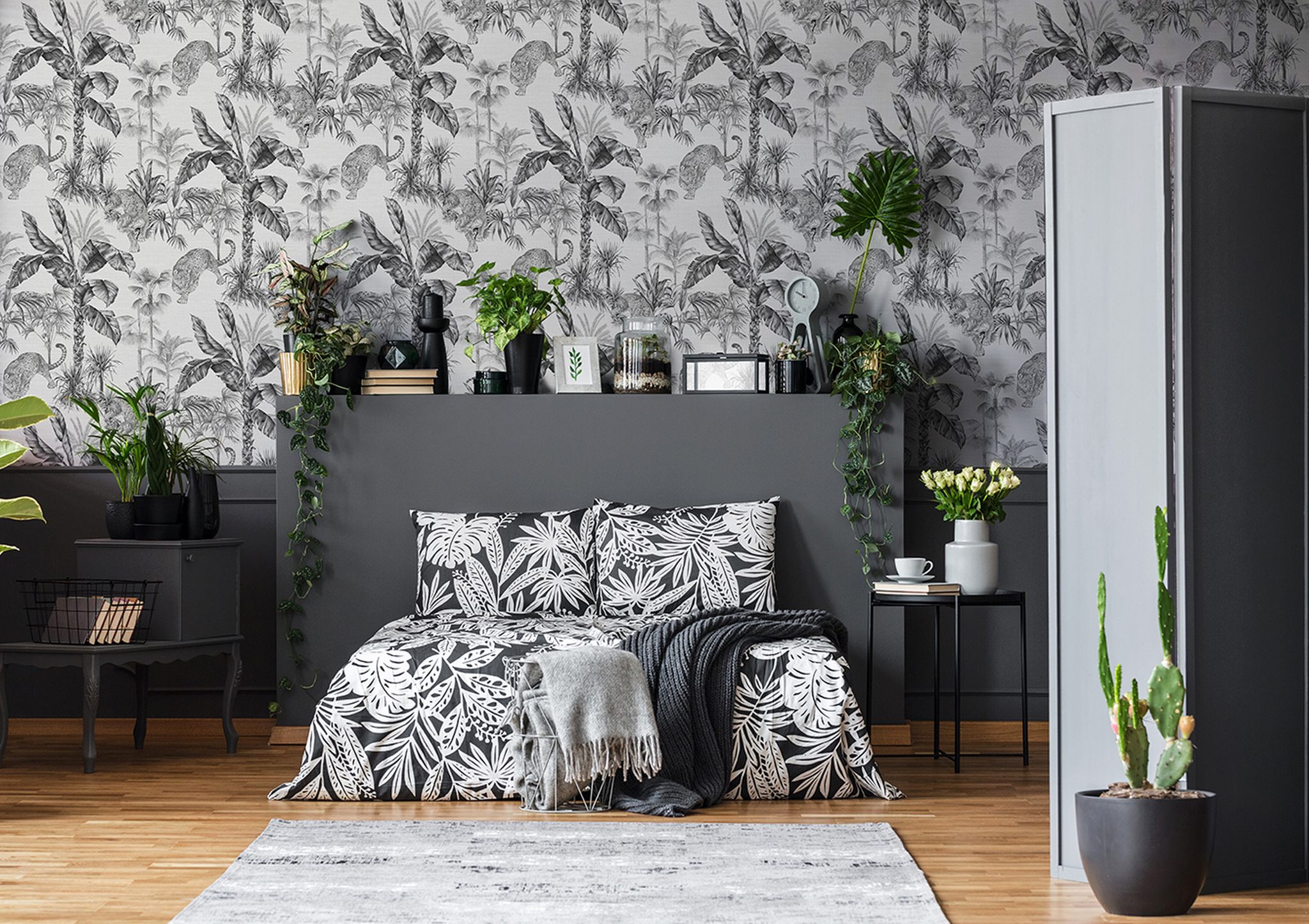 The 108598 Zanzibar Grey Wallpaper features majestic leopards prowling around a tropical foliage in this beautiful jungle design