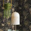 Ateles Charcoal is a painterly tropical-themed wallpaper featuring spider monkeys climbing in palm trees, set on a matt background.