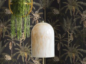 Ateles Charcoal is a painterly tropical-themed wallpaper featuring spider monkeys climbing in palm trees, set on a matt background.