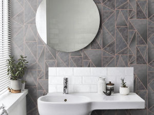 The 91142 Charon Charcoal Rosegold is a shard geometric wallpaper design with an ombre effect and high shine geometric lines in rosegold.