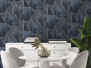 Charon Navy Gold wallpaper is a shard geometric design with an ombre effect within each shard. The geometric lines are in high shine gold metallic.