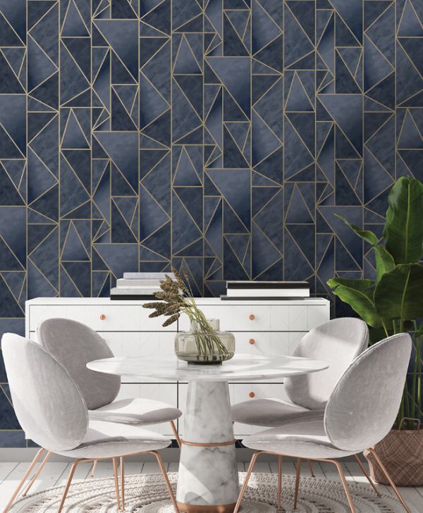 Charon Navy Gold wallpaper is a shard geometric design with an ombre effect within each shard. The geometric lines are in high shine gold metallic.