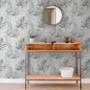 Chalky Tropical wallpaper features a gorgeous mix of leaves in light navy tones upon a crisp, white matt paper.