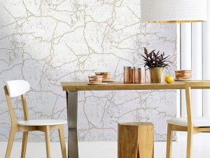 Kintsugi Gold wallpaper creates a stylish gold marble effect on a textured ivory background. It is a versatile design suitable for any room.