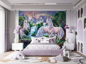 Unicorn Paradise Wall Mural features a small troop of unicorns frolicking along a forest river, a castle sitting atop a hill and colorful birds on trees.