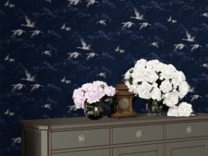 Animalia Midnight Wallpaper is a gorgeous pattern of grey and white cranes, amongst the outline of clouds on a dark blue background