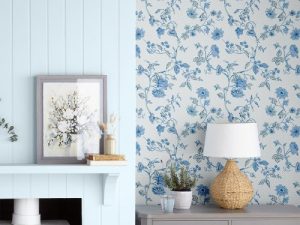 Rambling Rector Blue Sky Wallpaper is a beautifully delicate floral print, featuring fine meandering stems with offshoots of dainty flowers and leaves.
