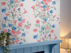 Charlotte Coral Pink Wallpaper features intertwined bunches of sweetpeas cast amongst scrolling tendrils and falling leaves and has a beautiful vintage feel