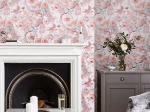 Birtle Blush Wallpaper features charming birds perched upon exotic tree branches alongside blooming roses and poppies with natural glamour.