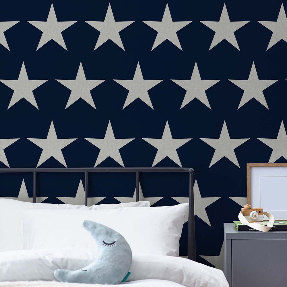 Stars Navy Blue wallpaper will add character and style to any childrens' room, an iconic star print comes to life in a deep navy blue with off-white stars.