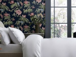 Birds & Blooms Navy Wallpaper is a beautiful floral wallpaper with majestic birds perched upon branches sat upon a deep navy background.