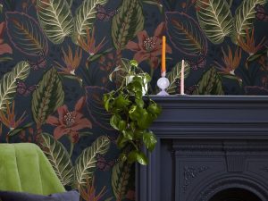 Eden Night wallpaper features a dark navy background with tropical florals and leaves, in a super large repeat to create real drama on your wall.