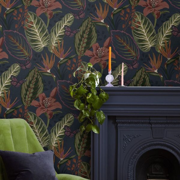 Eden Night wallpaper features a dark navy background with tropical florals and leaves, in a super large repeat to create real drama on your wall.